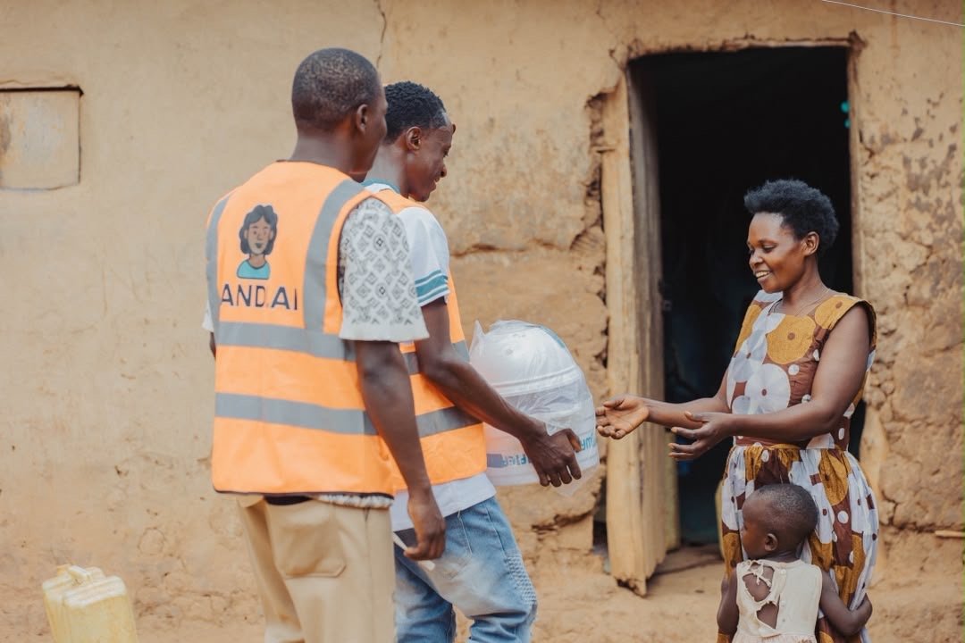 SandiLyt team delivering a household water purifier to a mother