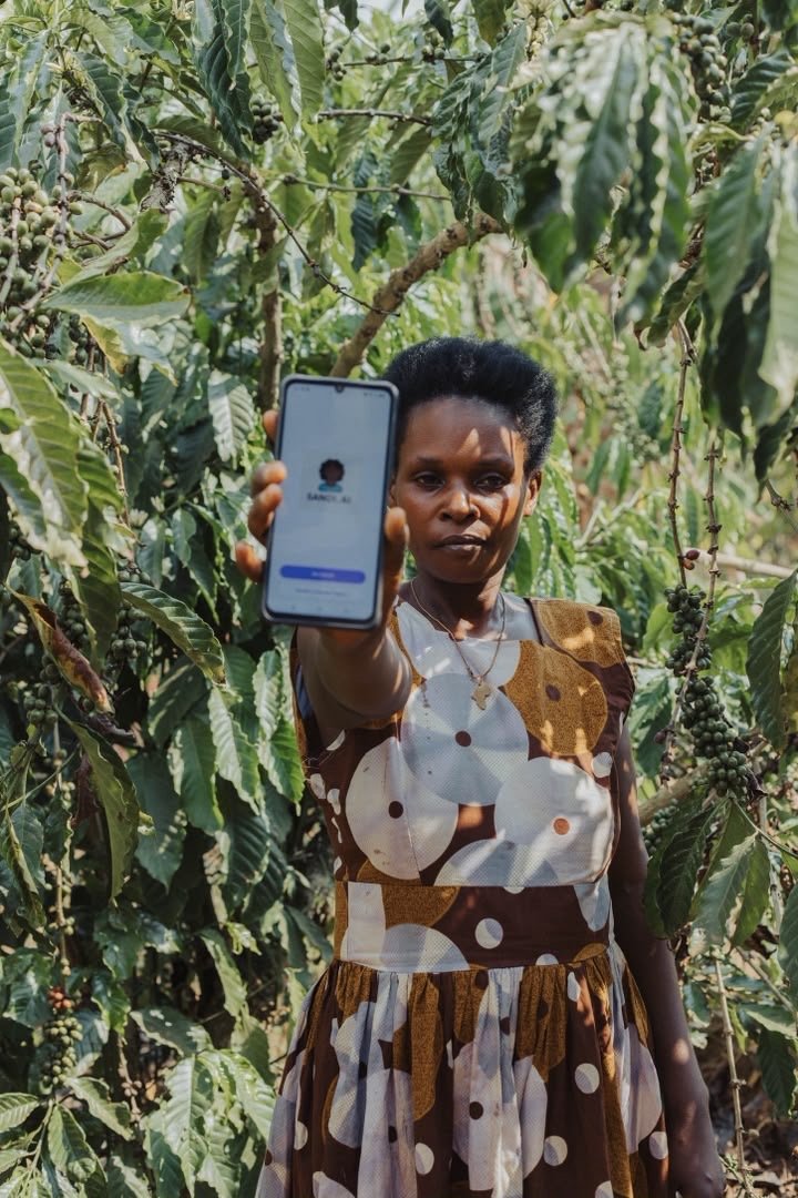 A woman holding up the SandiLyt mobile app
